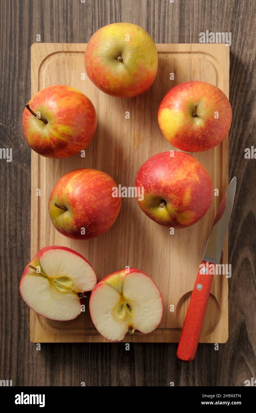 Fresh Rubinette apples on a chopping board Stock Photo