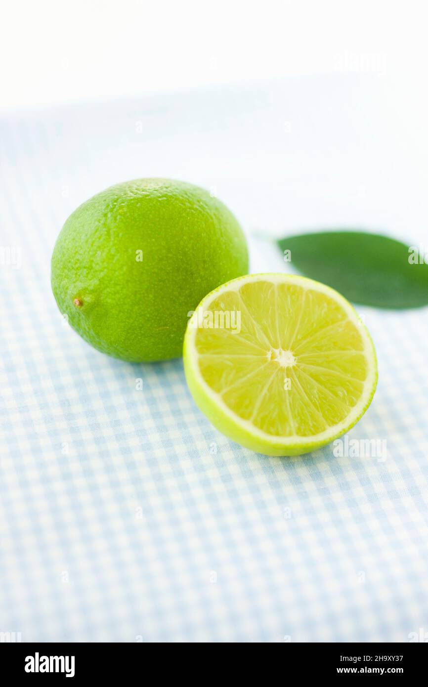 Limes, whole and halved Stock Photo