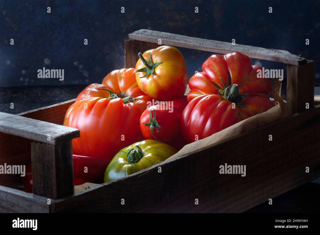 Various types of tomatoes in crate Stock Photo Alamy