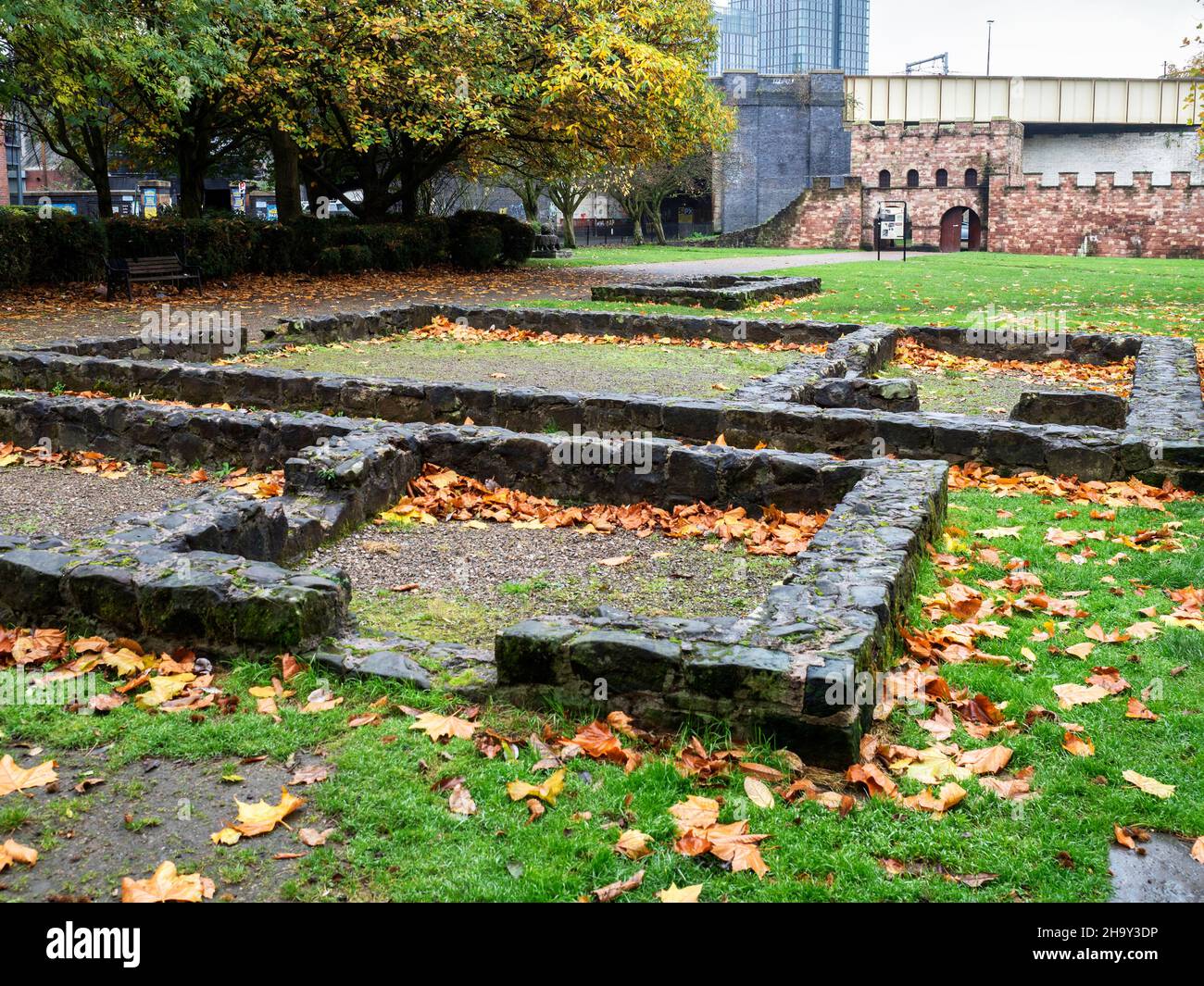 Remains of the roman fort and reconstructed gatehouse beyond at Castlefield Manchester Greater Manchester England Stock Photo