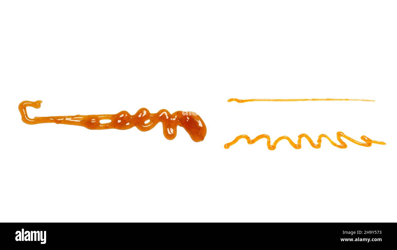 Orange apricot jam splashes isolated on white background. Top view. Stock Photo
