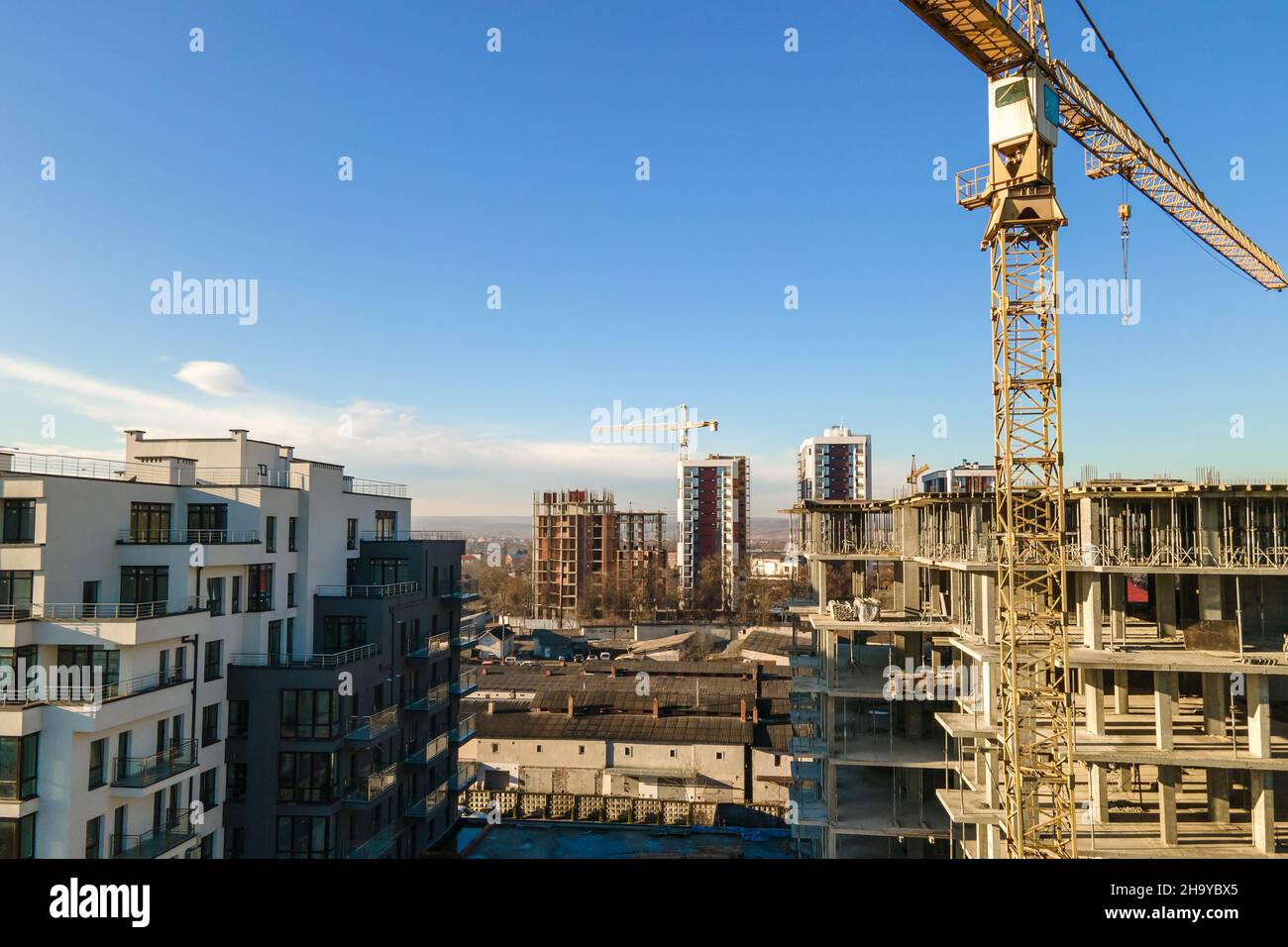 Aerial view of high tower crane and residential apartment buildings ...