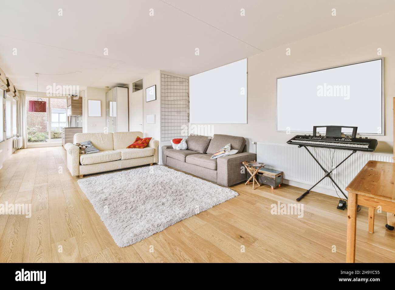 Lovely living room with milky and gray sofas and shaggy carpet Stock Photo