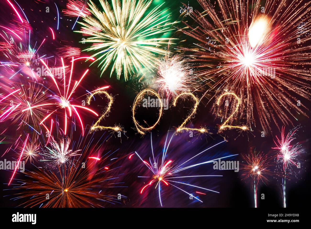 2022 Happy New Year with Sparkle firework on black background. Fireworks in sky Stock Photo