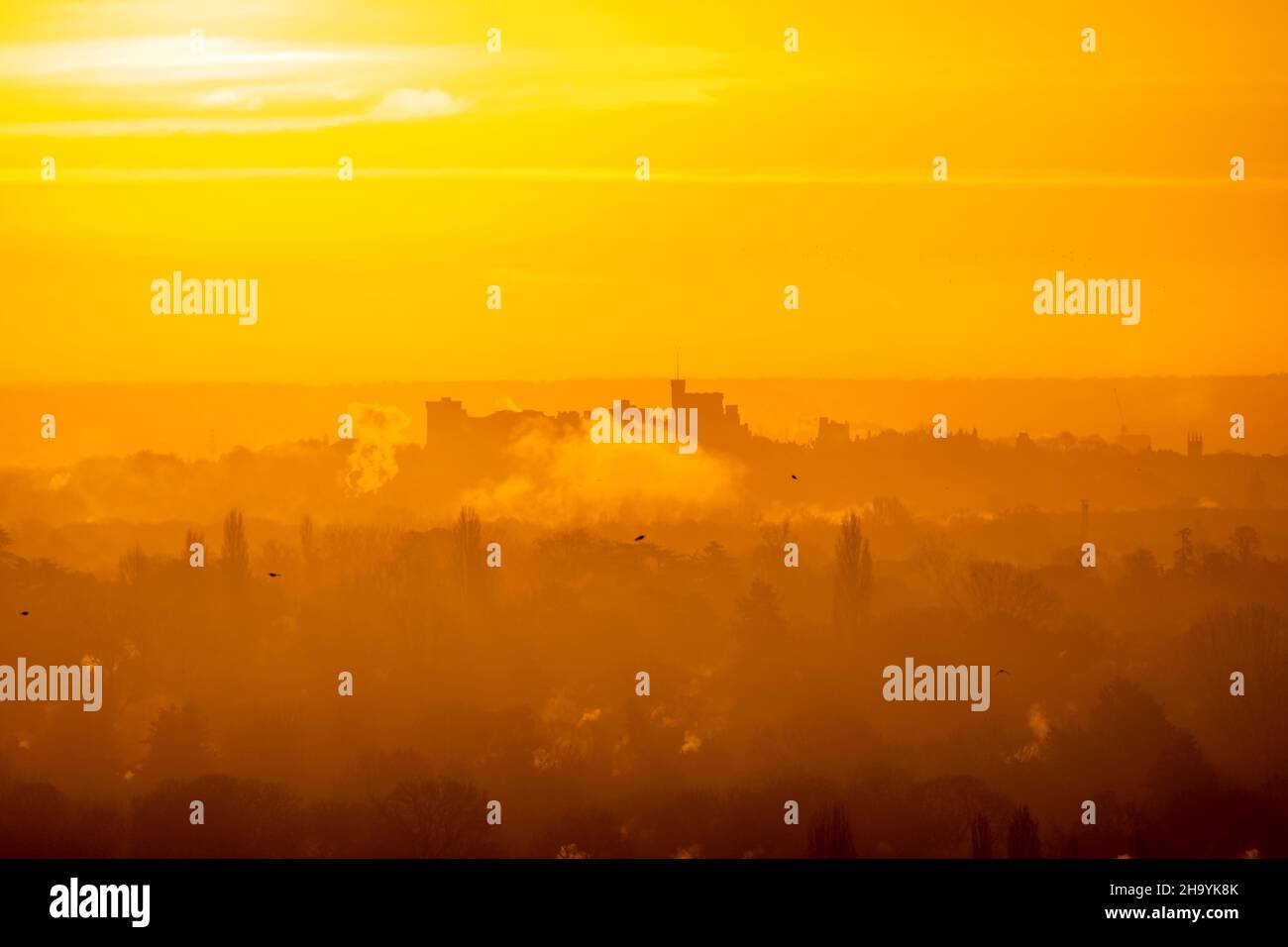 Winter Sunrise with Windsor castle emerging from mist on horizon Stock Photo