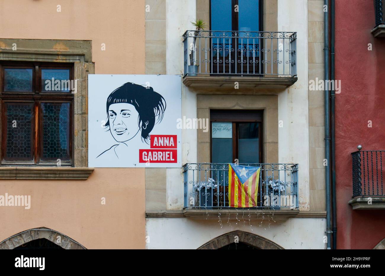 Independence banners and depictions of Catalan politician Anna Gabriel on buildings in the Catalan city of Vic, Catalonia, Spain Stock Photo