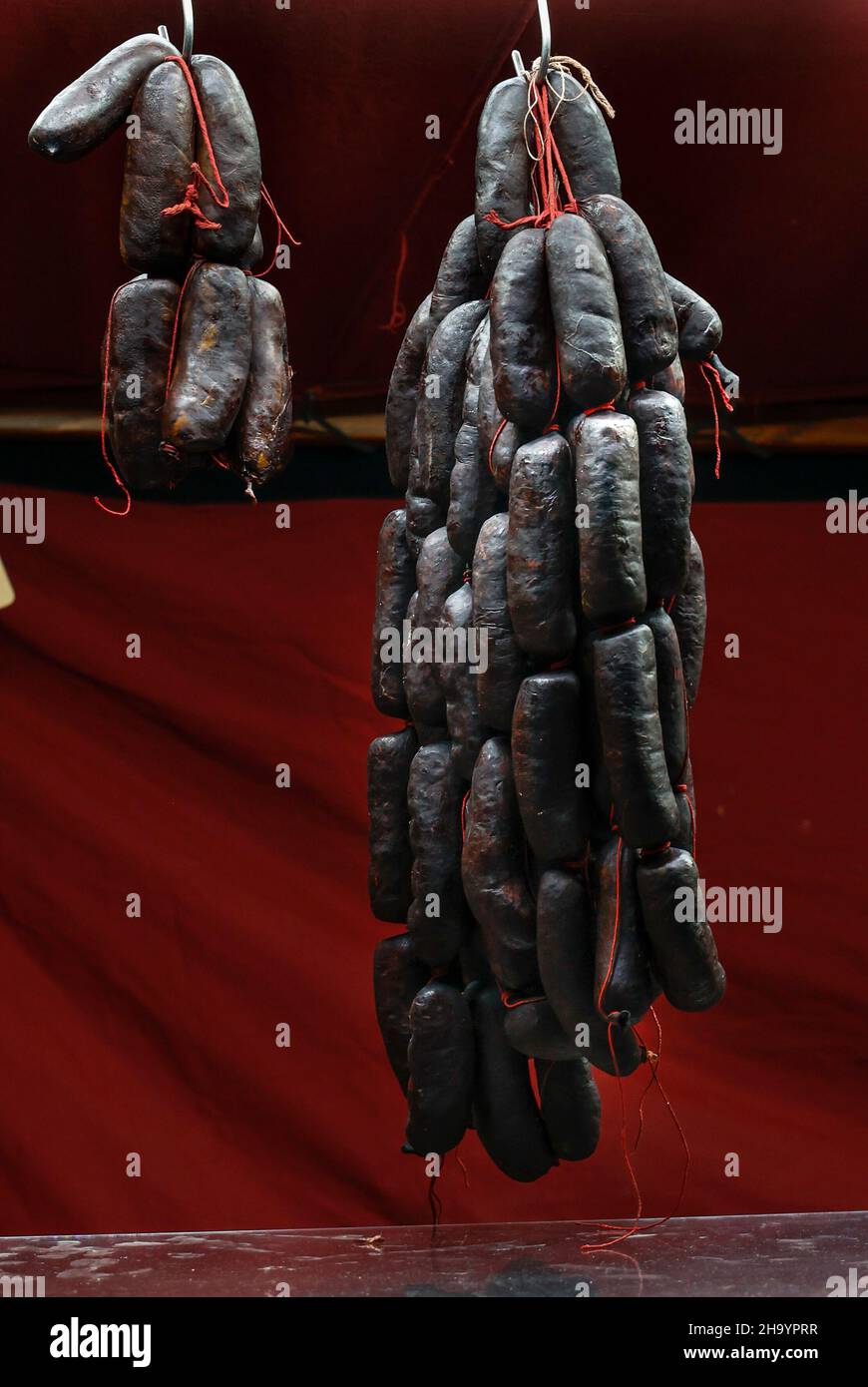 Cured pork meat sausages for sale on a market stall in Vic, Catalonia, Spain Stock Photo