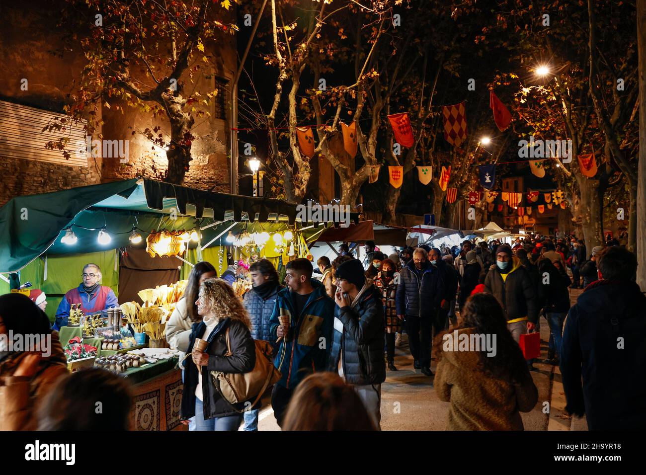Market stalls and banners in the Medieval Christmas market in the town of Vic in Catalonia, Spain Stock Photo