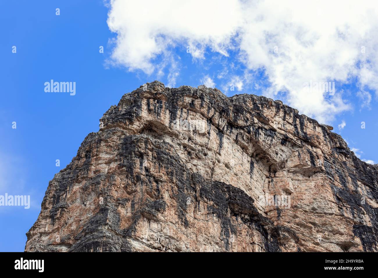 Dolomite rock peak with typical texture and color against blue sky Stock Photo