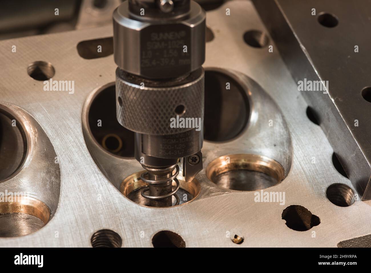 Grinding valve seats on car engine cylinder block Stock Photo Alamy