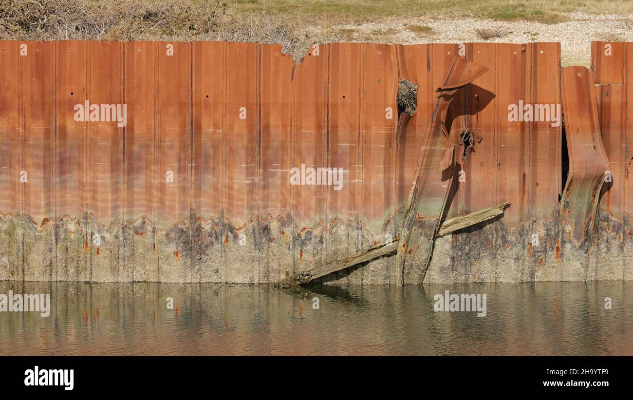 Remnants of an old rusted metal structure seen in Pagham Harbour. Stock Photo