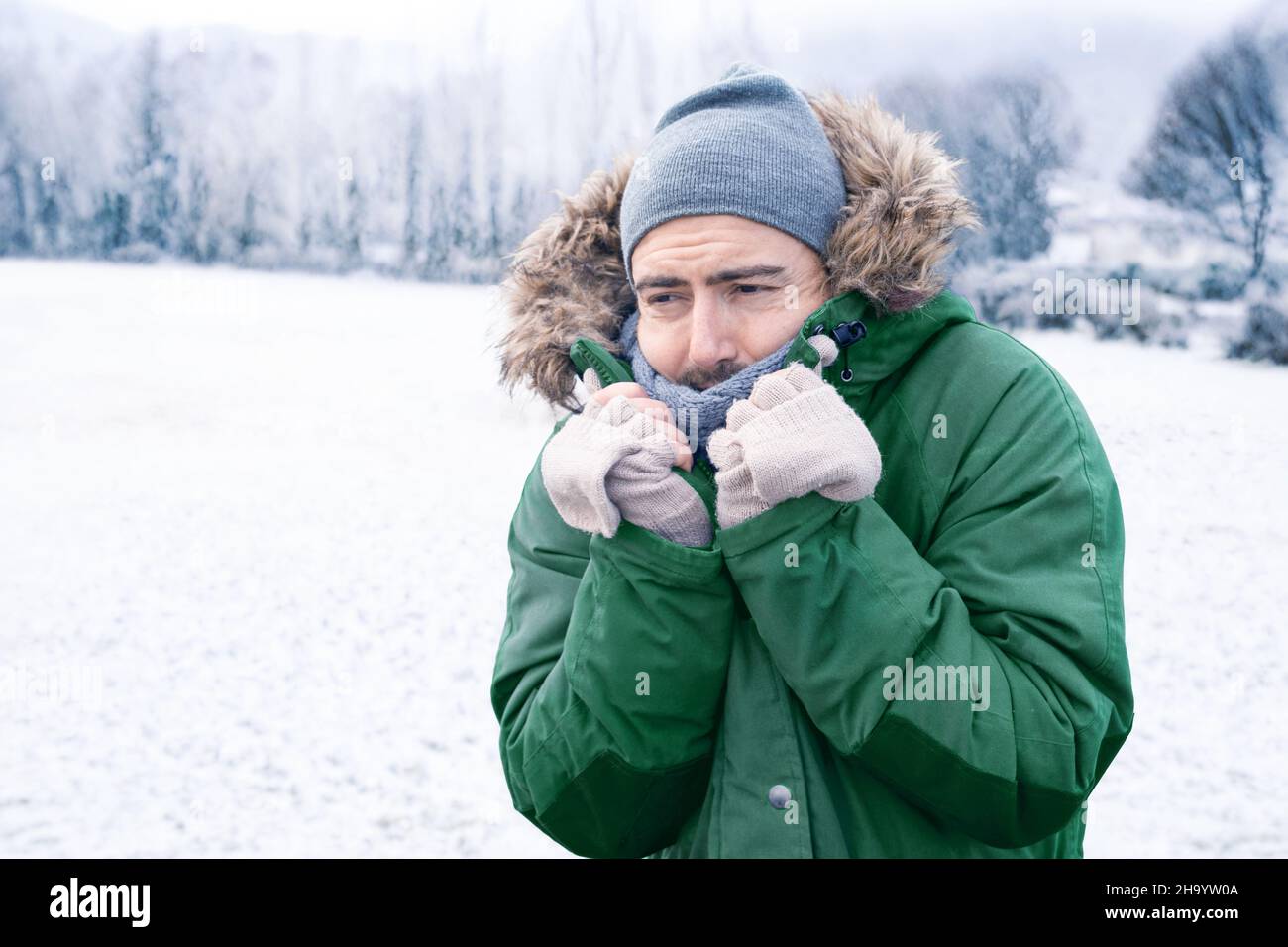 Man In Winter Clothes Shivering From The Cold Stock Photo, Picture and  Royalty Free Image. Image 12116568.