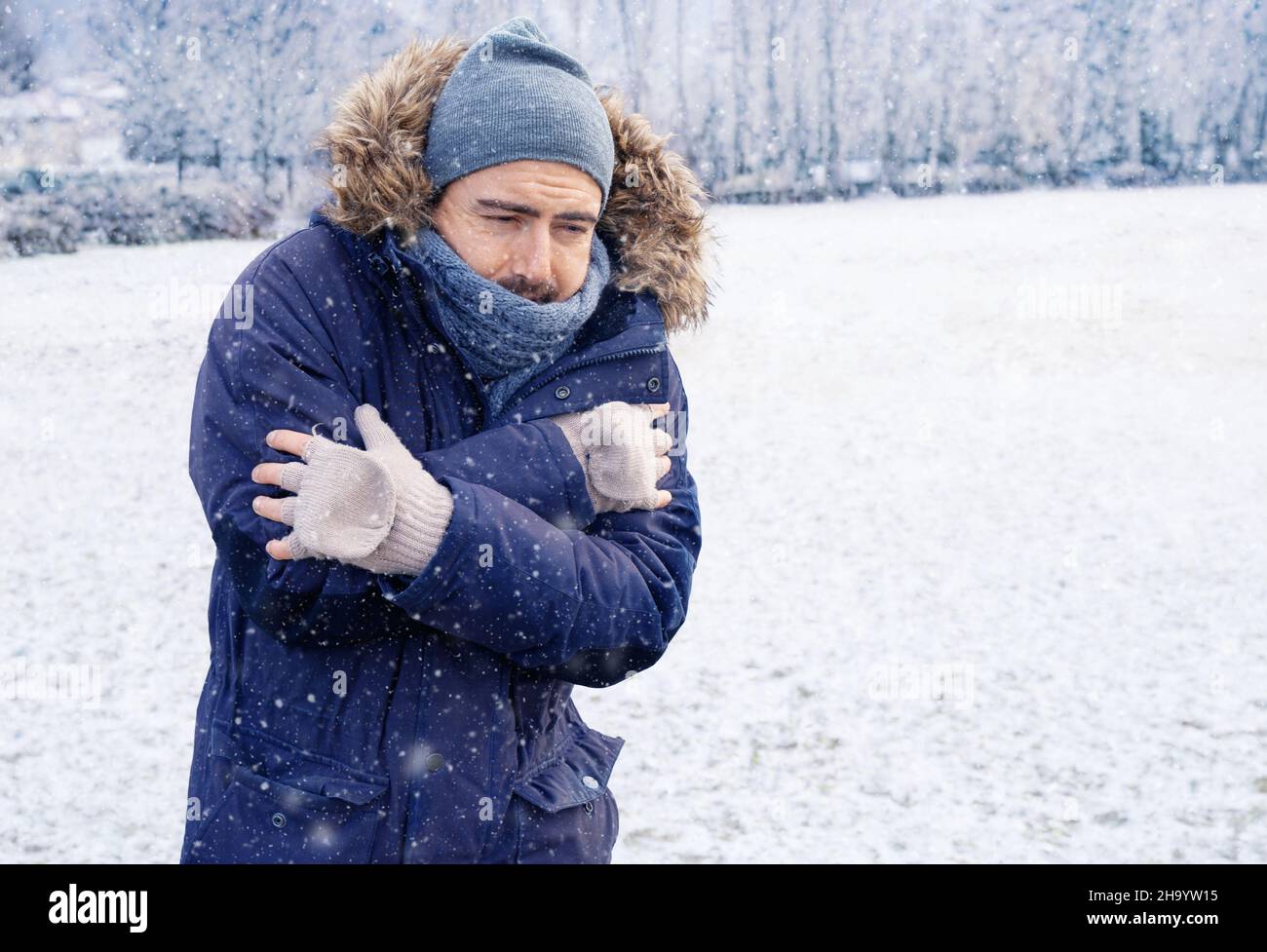 One man suffering and shivering because of cold weather Stock Photo