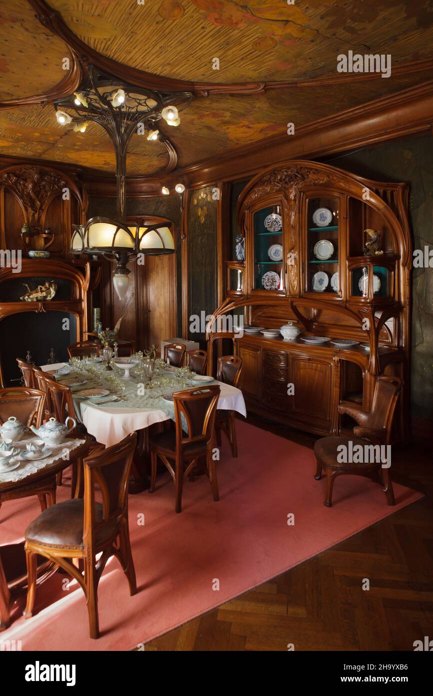 Art Nouveau dining room designed by French furniture designer Eugène Vallin (1903-1906) on display in the Museum of the Nancy School (Musée de l'École de Nancy) in Nancy, France. Art Nouveau ceiling panels and leather wall decoration were designed in collaboration with French artist Victor Prouvé. This furniture set was commissioned by French businessman Charles Masson for his apartment in Nancy. Stock Photo