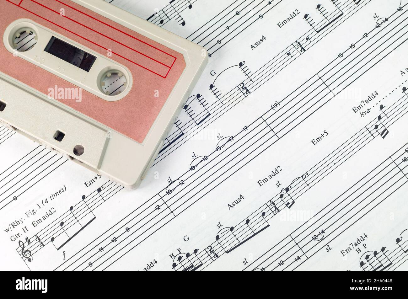 Close up photo of old cassette tape and music notes Stock Photo