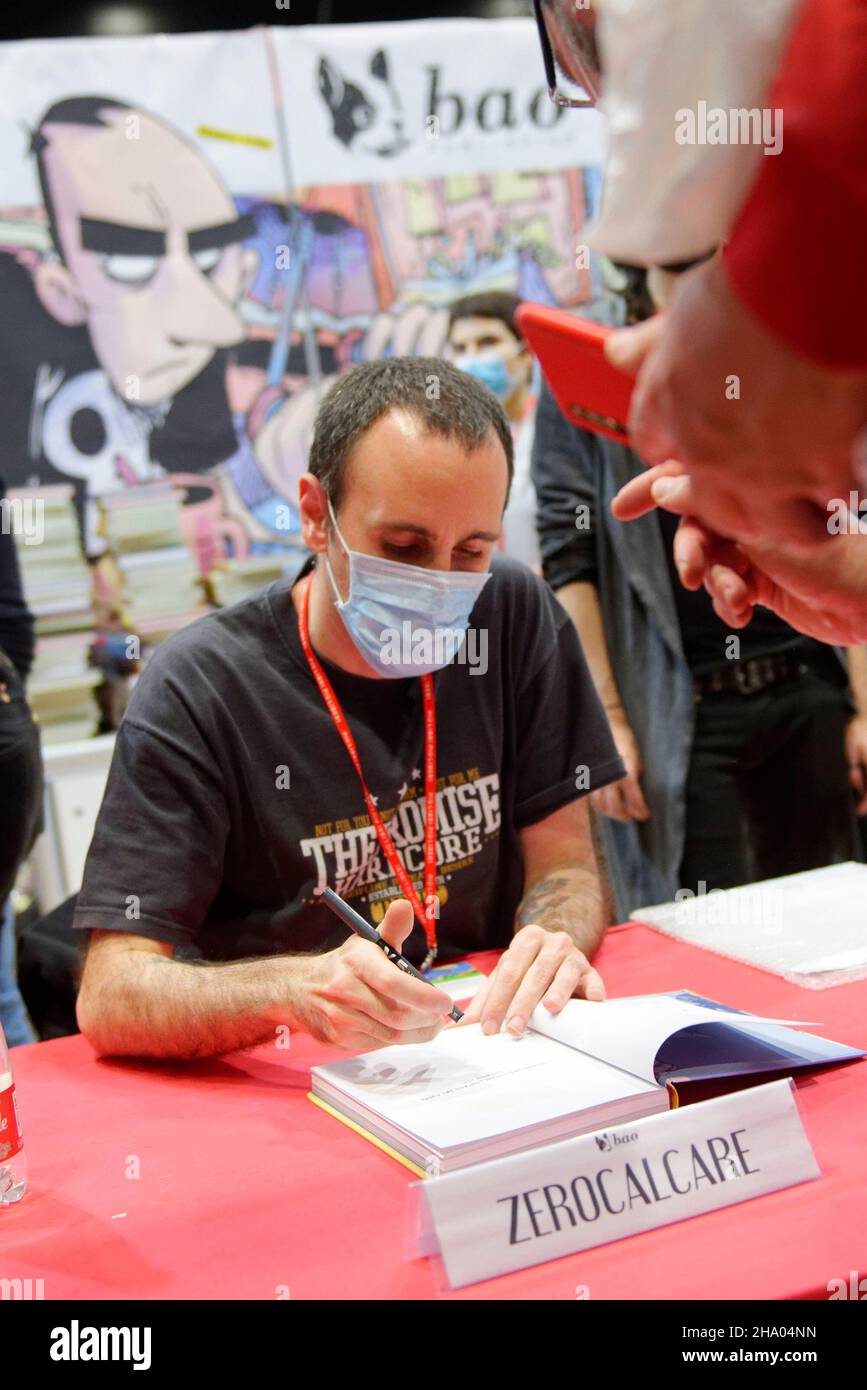Italian cartoonist Michele Rech, also known as Zerocalcare, signs a copy of  a book by him to a fan Stock Photo - Alamy