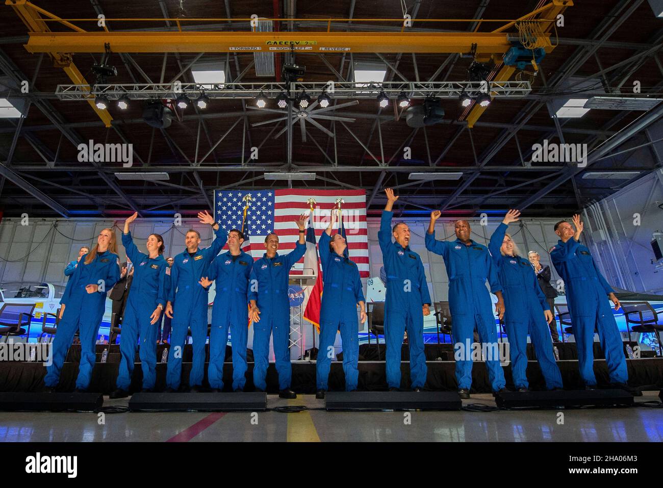 Houston, United States. 06 December, 2021. NASA astronaut candidates wave after being introduced during an event announcing the new class of 10 candidates at Ellington Field on the Johnson Space Center, December 6, 2021 in Houston, Texas. Standing from left to right are: Nichole Ayers, Christina Birch, Luke Delaney, Andre Douglas, Christopher Williams, Jessica Wittner, Anil Menon, Andre Douglas, Deniz Burnham and Marcos Berrios.  Credit: James Blair/NASA/Alamy Live News Stock Photo