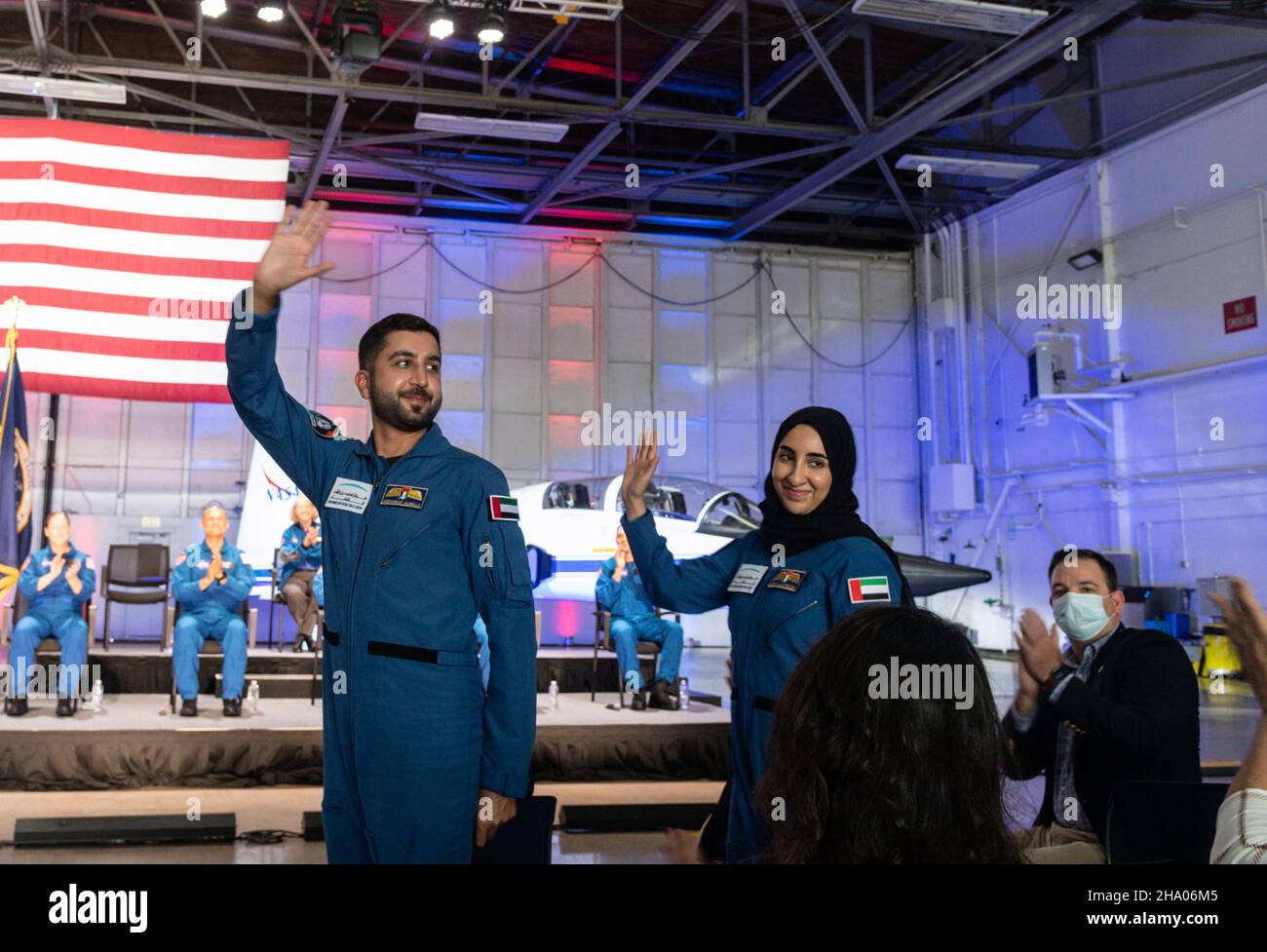 Houston, United States. 06 December, 2021. United Arab Emirates astronaut candidates Mohammad Al Mulla, left, and Nora Al Matrooshi wave during an event announcing the new class of candidates at Ellington Field on the Johnson Space Center, December 6, 2021 in Houston, Texas.  Credit: Robert Markowitz/NASA/Alamy Live News Stock Photo