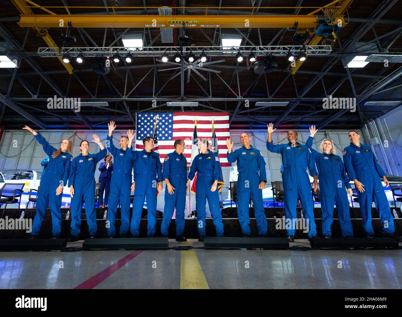 Houston, United States. 06 December, 2021. NASA astronaut candidates wave after being introduced during an event announcing the new class of 10 candidates at Ellington Field on the Johnson Space Center, December 6, 2021 in Houston, Texas. Standing from left to right are: Nichole Ayers, Christina Birch, Luke Delaney, Andre Douglas, Christopher Williams, Jessica Wittner, Anil Menon, Andre Douglas, Deniz Burnham and Marcos Berrios.  Credit: James Blair/NASA/Alamy Live News Stock Photo