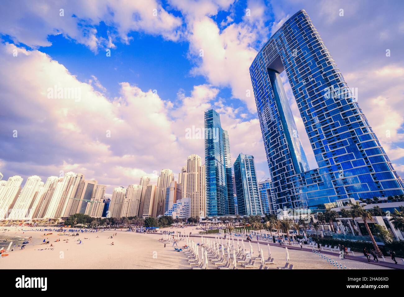 Scenic view of the skyline of the Dubai Marina district with it's tall skyscrapers raising next to the beach and the waterfront, Dubai, UAE Stock Photo