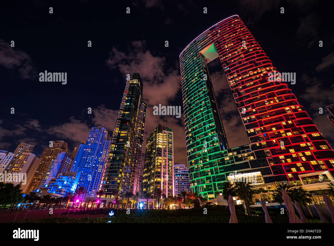 Scenic night view of the skyline of the Dubai Marina district with it's tall skyscrapers raising next to the beach and the waterfront, Dubai, UAE Stock Photo