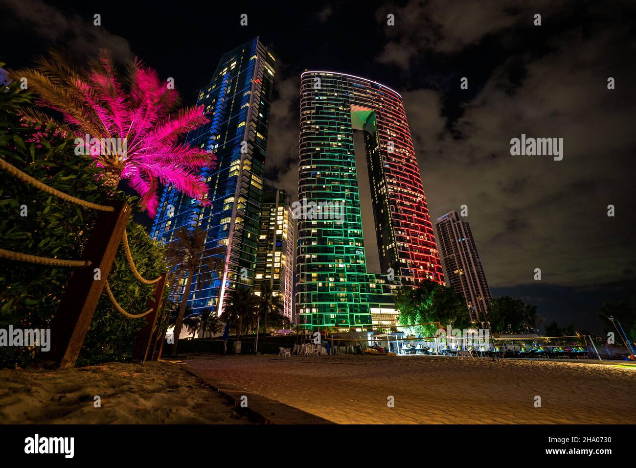 Scenic night view of the skyline of the Dubai Marina district with it's tall skyscrapers raising next to the beach and the waterfront, Dubai, UAE Stock Photo