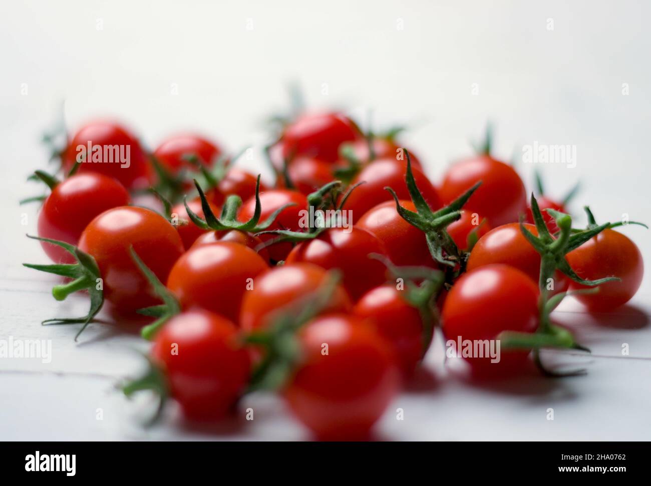 Closeup shot of a bunch of cherry tomatoes isolated on a white ...