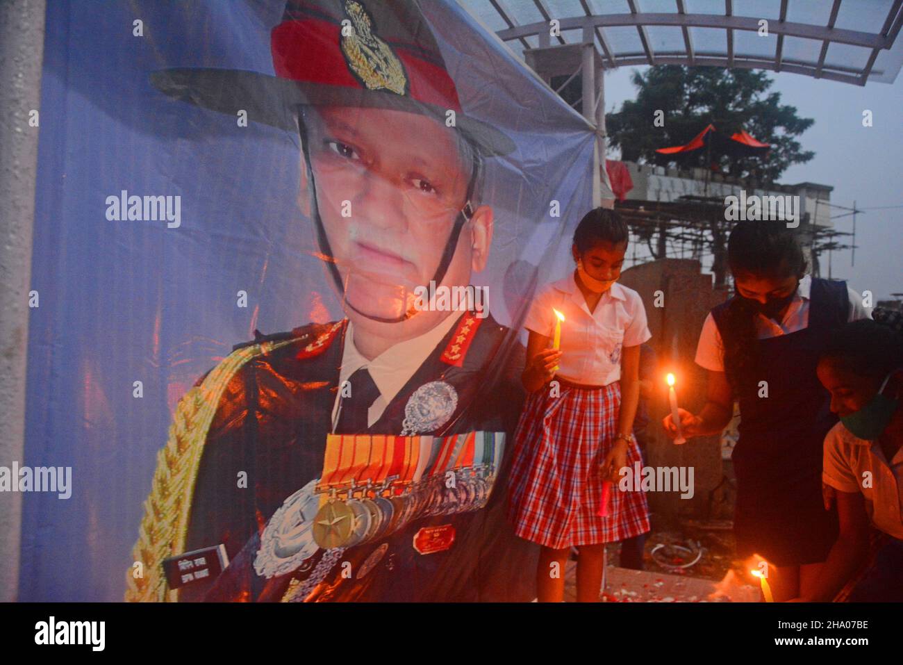Kolkata, West Bengal, India. 9th Dec, 2021. People lit candles to pay their respect in front of a portrait of Chief General Bipin Rawat. A candle light march was organized today to pay homage to CDS General Bipin Rawat and his wife and the 11 Heroes who lost their lives in a helicopter crash yesterday in Tamil Nadu's Coonoor.School students were presented there. While some honored the great soldier by lighting candles, elsewhere people were laying wreaths and paying floral tributes to the Army officer. (Credit Image: © Rahul Sadhukhan/Pacific Press via ZUMA Press Wire) Stock Photo