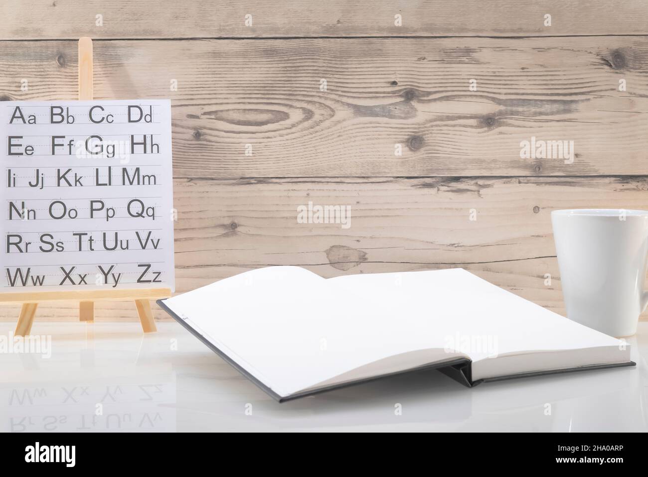 Book opened on a workspace. White pages for inscriptions. Stock Photo