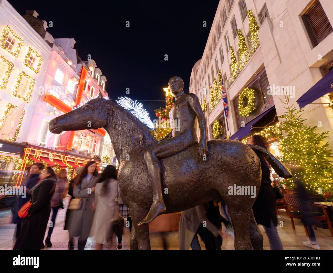 London, Greater London, England, December 04 2021: Horse and Rider Bronze sculpture by Elisabeth Frink on New Bond Street at night in Christmas time. Stock Photo