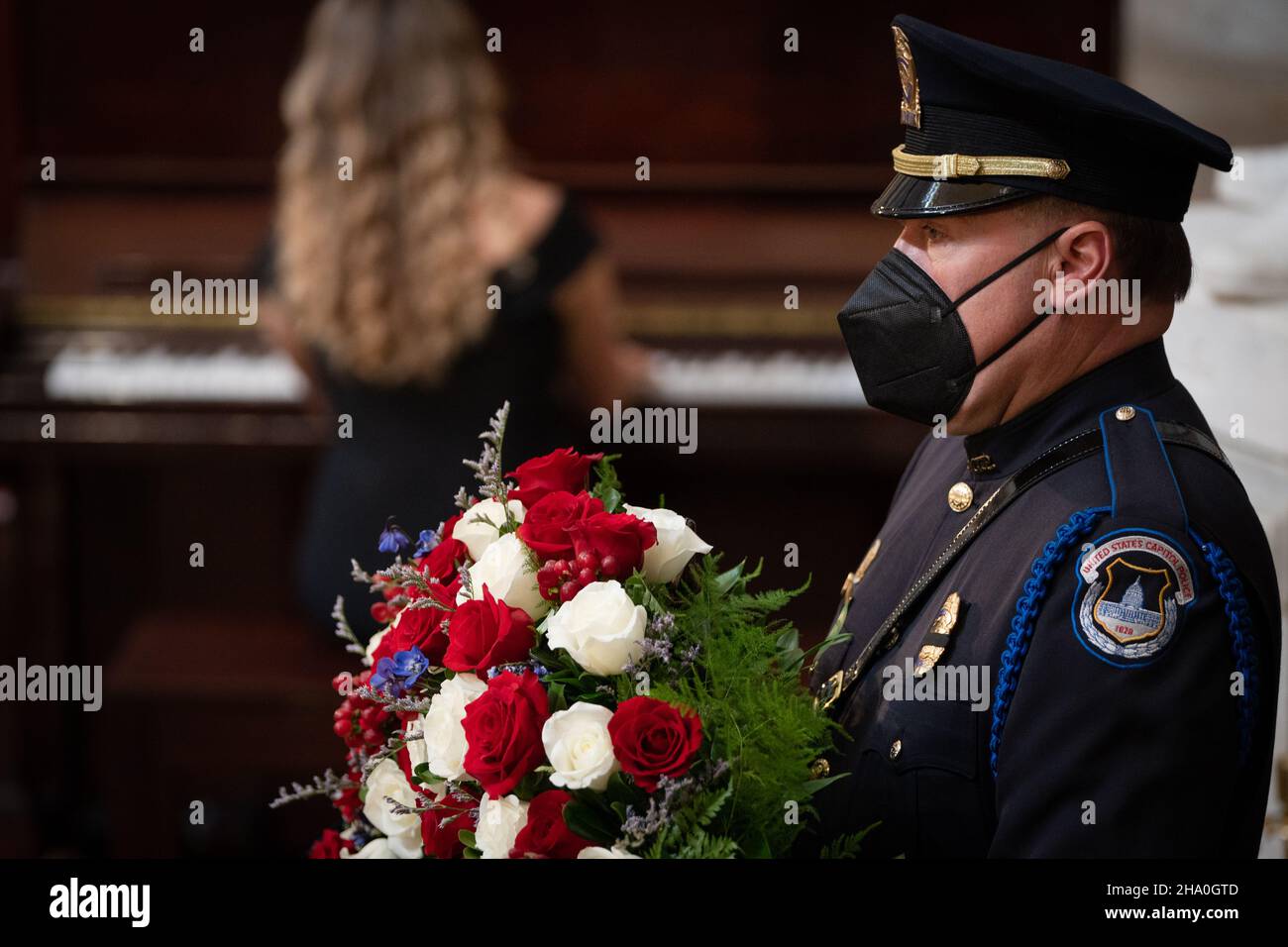 A Capitol Police officer pays respect to former Senator Robert J. Dole (R-KS) as he lies in state at the Rotunda of the U.S. Capitol in Washington, DC on Thursday, December 9, 2021.Credit: Sarahbeth Maney/Pool via CNP /MediaPunch Stock Photo