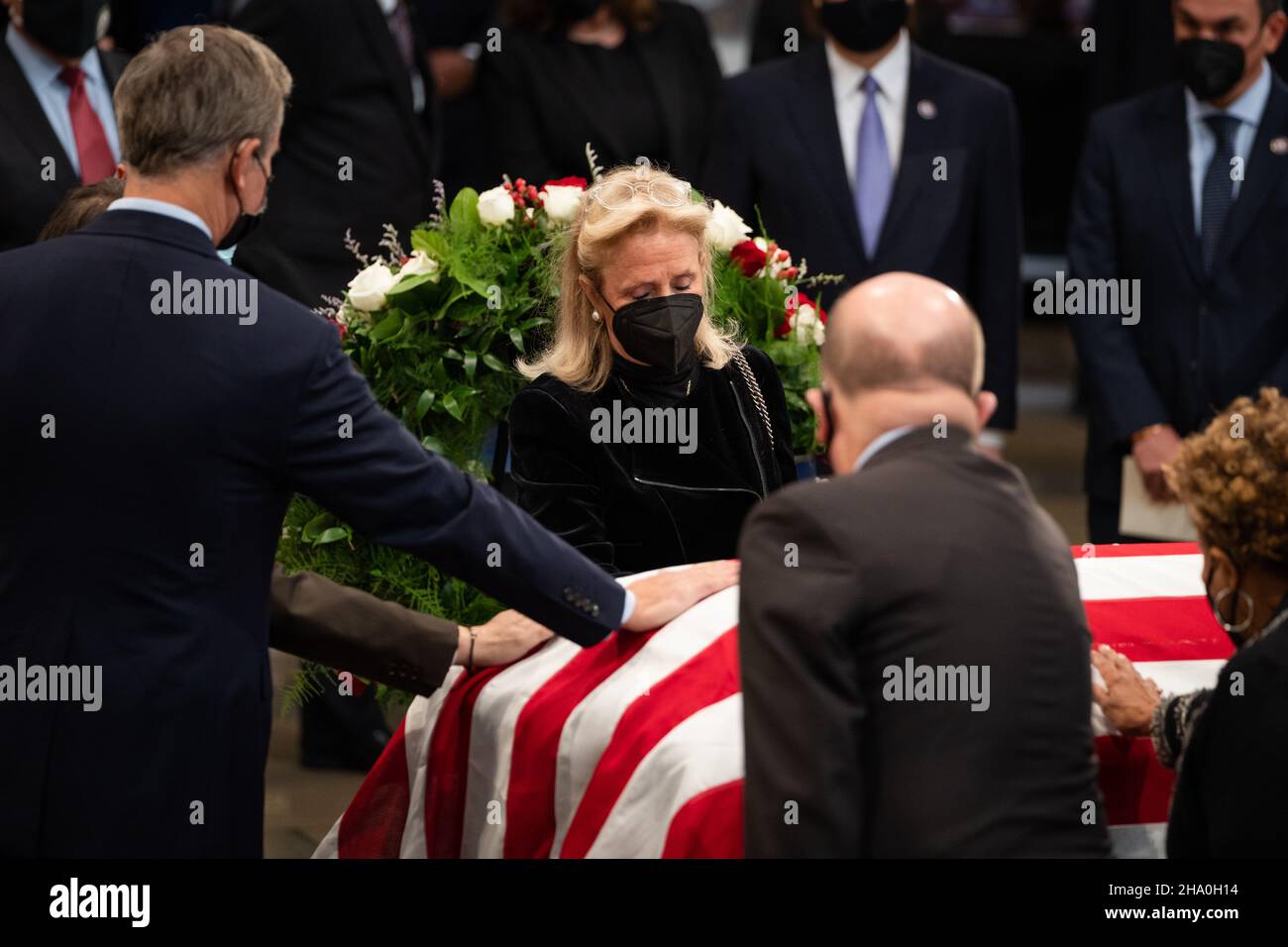 United States Representative Debbie Dingell (Democrat of Michigan), center, flanked by fellow representatives, pays respect to former Senator Robert J. Dole (R-KS) as he lies in state at the Rotunda of the U.S. Capitol in Washington, DC on Thursday, December 9, 2021. Credit: Sarahbeth Maney/Pool via CNP /MediaPunch Stock Photo