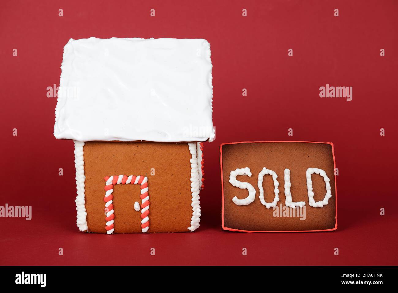 The hand-made eatable gingerbread house on red background Stock Photo