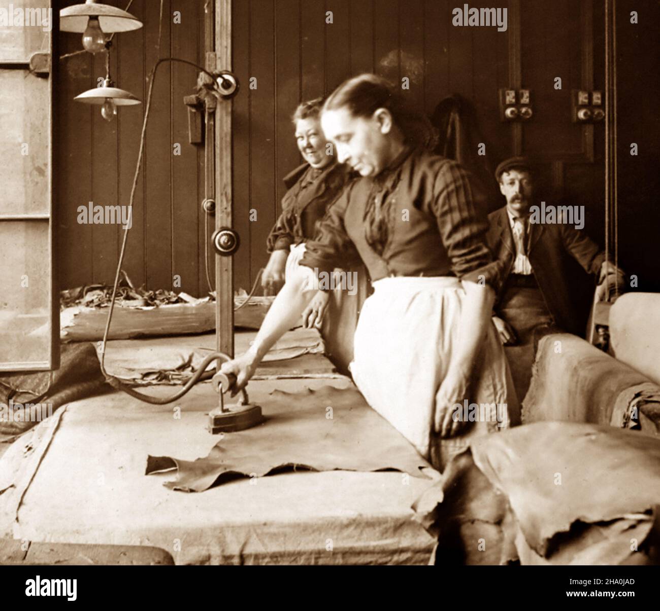 Ironing skins, leather production, Victorian period Stock Photo Alamy