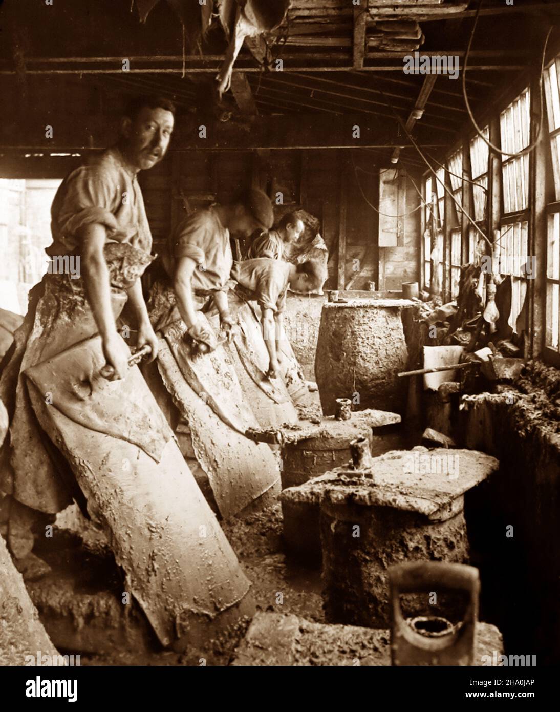 Removing hair from skins, leather production, Victorian period Stock Photo