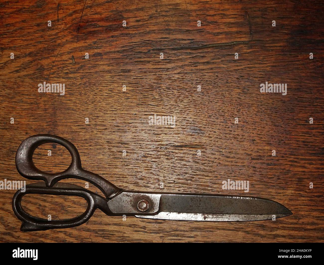 Old tailors scissors on wooden background Stock Photo