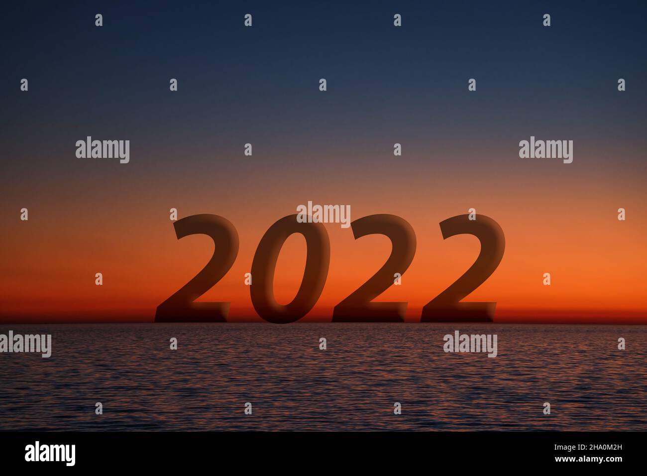 The silhouette of Number 2022 on Horizon at sunset with Orange and Red colors Background, New Year 2022. Beautiful sunset over the ocean. Copy Space. Stock Photo