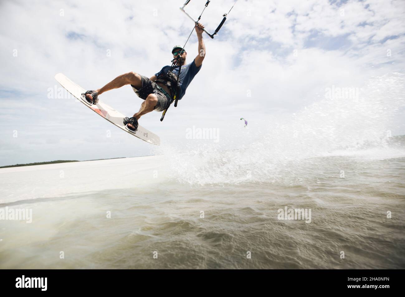 A man kiteboarding in the florida keys jumps out of the water Stock Photo Alamy