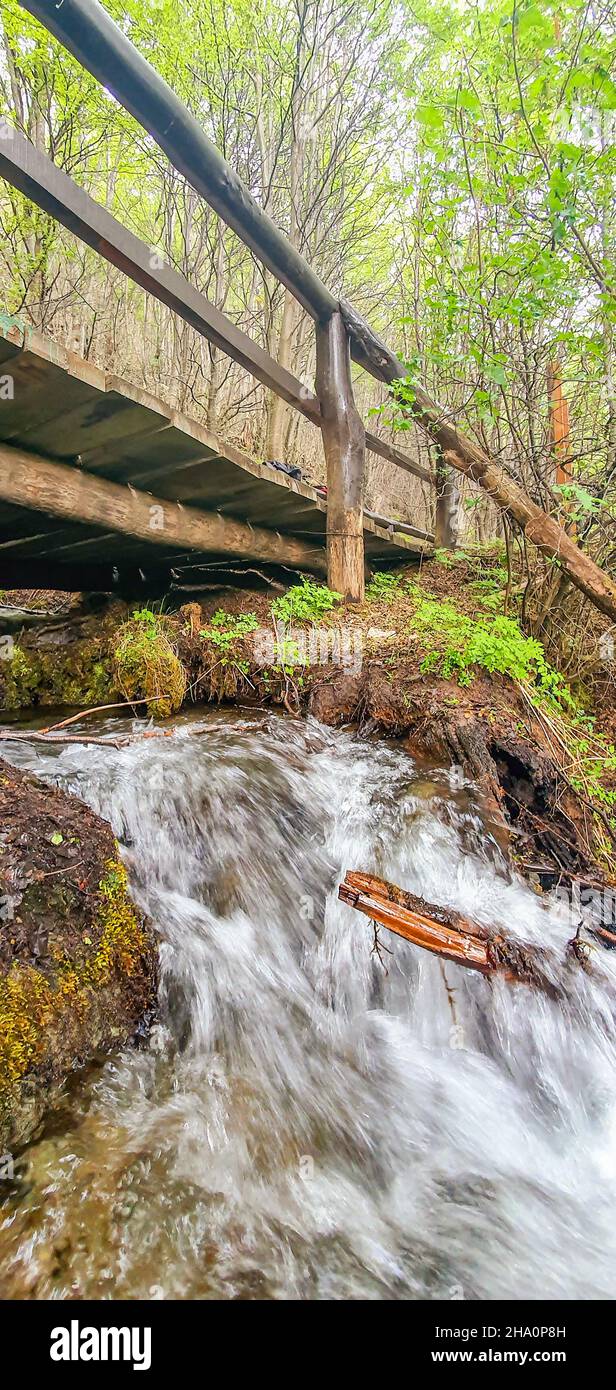 Waterfall flowing over the rocks under the bridge Stock Photo - Alamy
