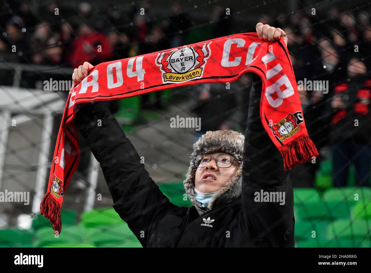 Fans of Ferencvarosi show their support as they hold scarves prior