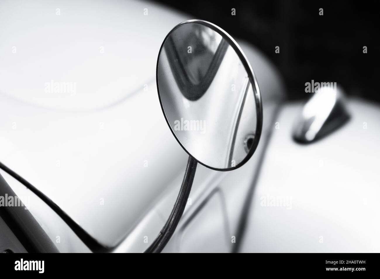 Round rearview mirror in chromed frame. Vintage car fragment, close up photo with selective soft focus Stock Photo