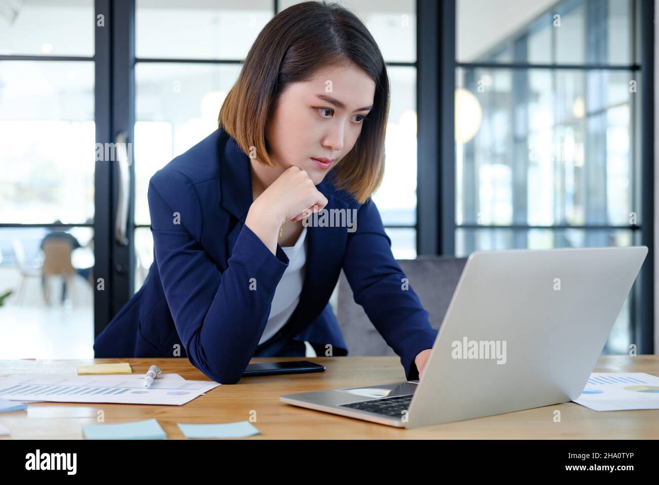 Portrait of beautiful and smart young entrepreneur businesswoman working in modern work station. Stock Photo