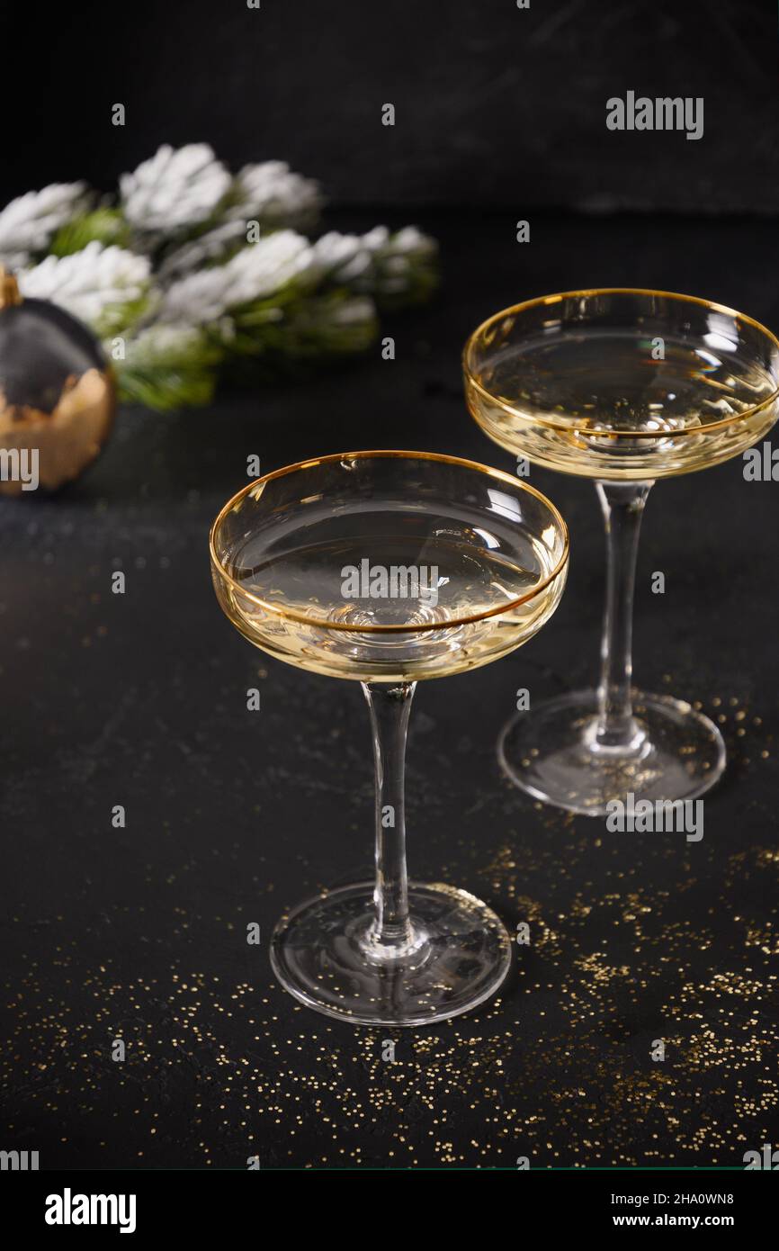 New Year champagne glasses and Christmas gold decorations on black ...