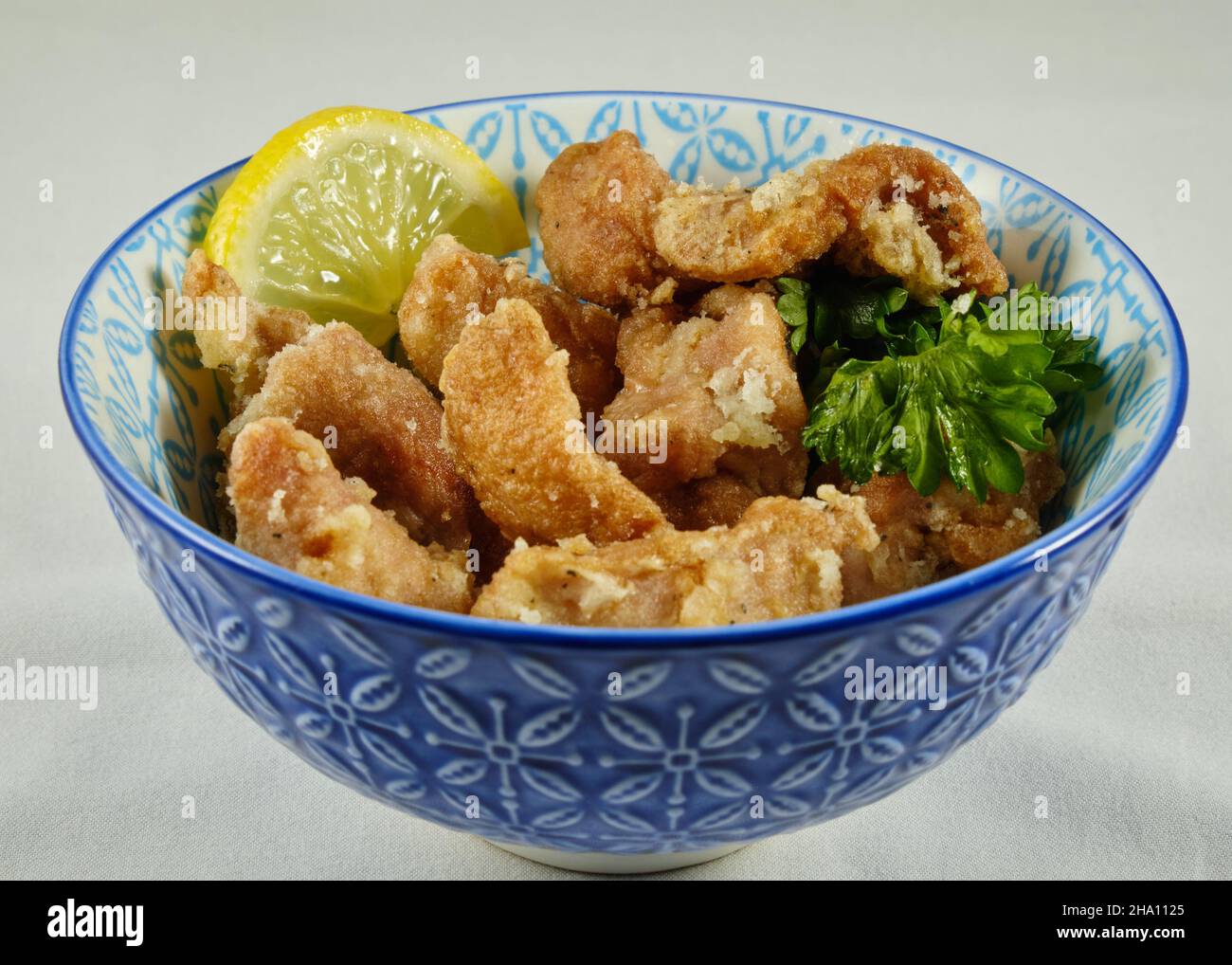 Small bowl of a portion of Japanese fried chicken, Karaage, displayed for serving Stock Photo