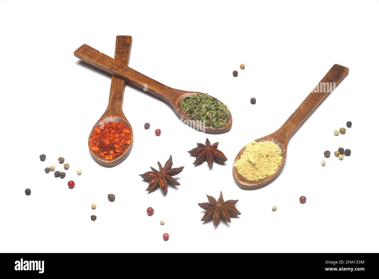 Different kind of spices on a white background. Oriental spices in spoons,  red peppers, curry powder, cinnamon powder, mint powder, colorful peppers  Stock Photo - Alamy