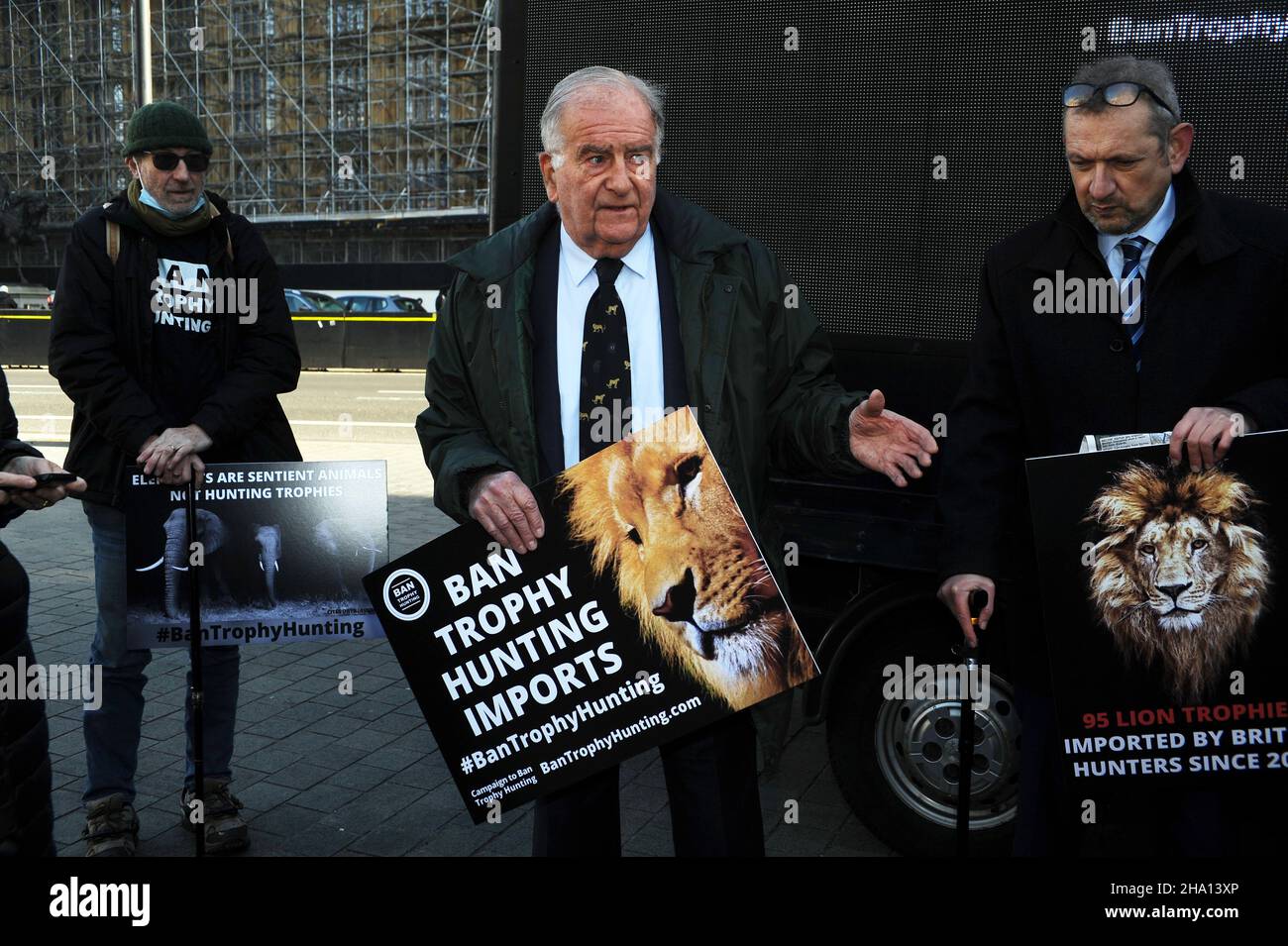 London, UK. 9th Dec, 2021. Campaign to Ban Trophy Hunting, a new all party parliamentary group newly launched display their new digital banner outside the Houses of Parliament which shows animal trophy heads on a luggage carousel. Credit: JOHNNY ARMSTEAD/Alamy Live News Stock Photo
