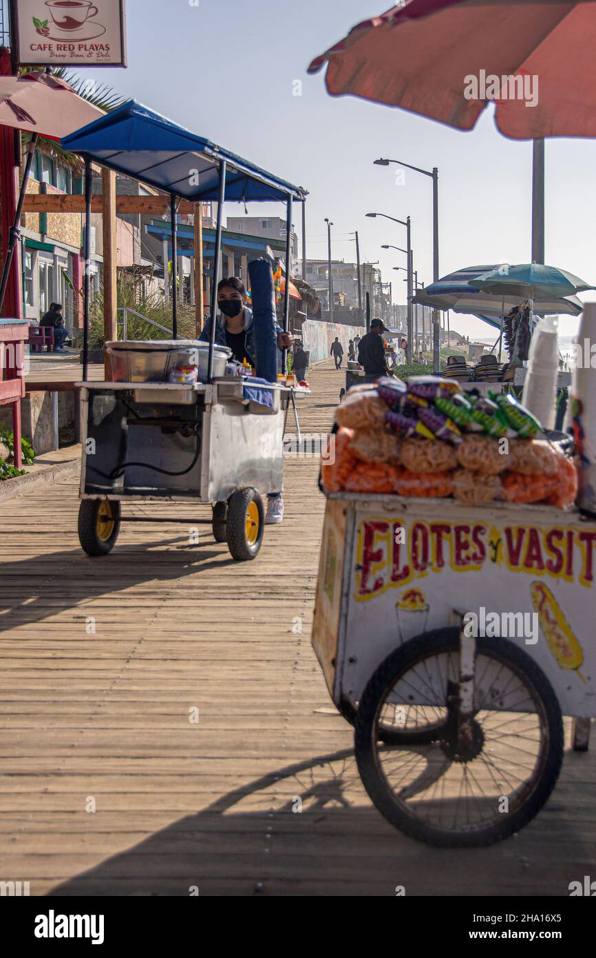 A Mexican vender pushes their cart across the Playas de Tijuana (Tijuana Beach) boardwalk, Tijuana, Baja California, Mexico. Stock Photo