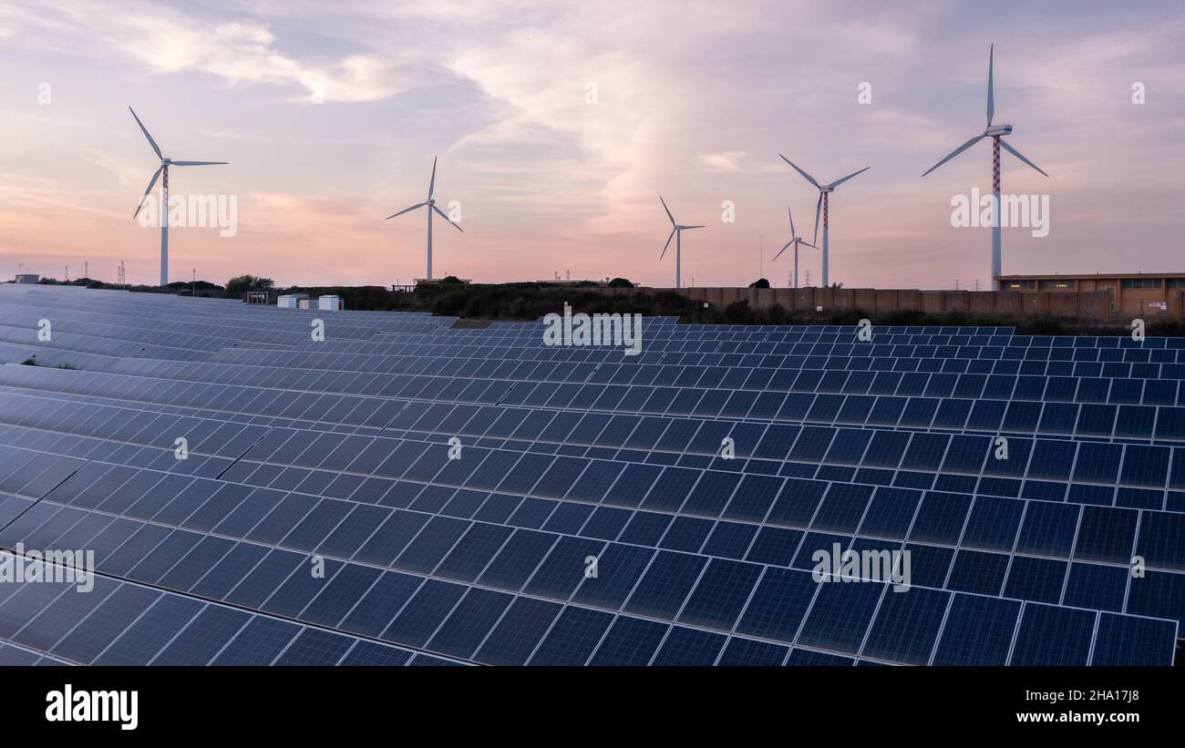 Solar panels and wind turbines producing green energy for clean ...