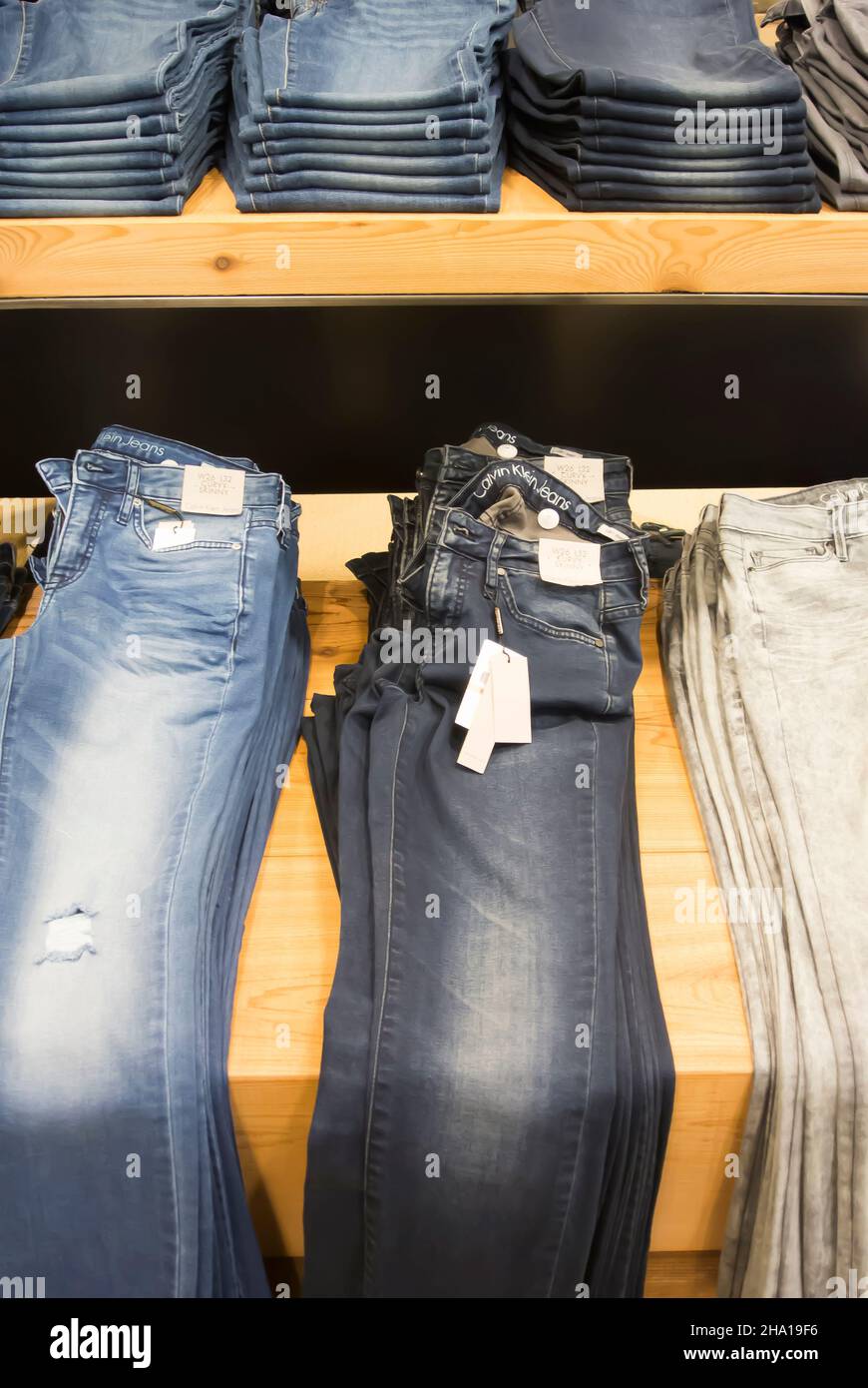 Jeans Displayed on Shelves for Sale Stock Photo