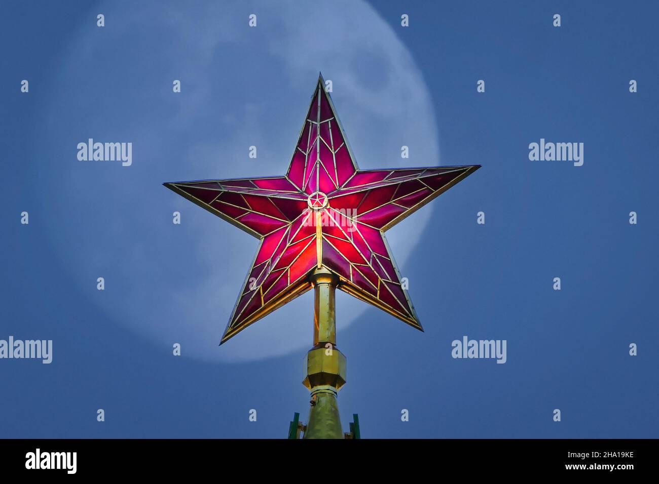 Red Kremlin star at night, full moon on background Stock Photo